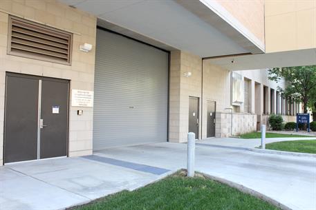 Large gray rolling steel door at a commercial building entrance
