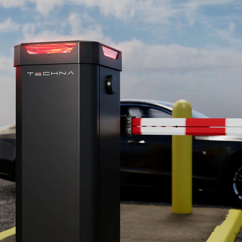 Black barrier gate operator with red and white striped arm at a commercial parking entrance